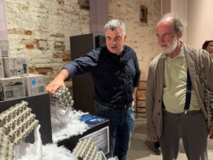 Prof. Sir Konstantin Novoselov engages with visitors, explaining the architectural implications of graphene-enhanced concrete structures.