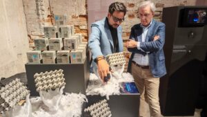 Visitors explore the modular concrete hands and cube assemblies, representing material intelligence and structural biomimicry.